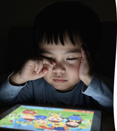 Child with an iPad late at night