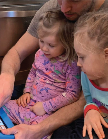Two children using an augmentative communication device