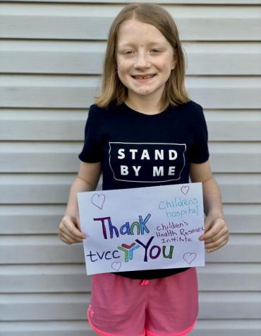 Jordyn holding a thank you TVCC sign