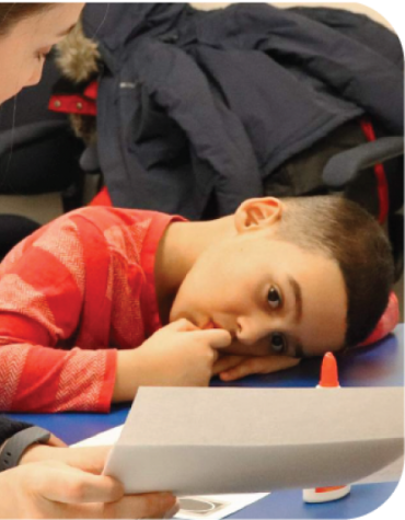 child looking at paper