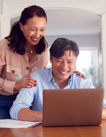 Husband and wife at laptop