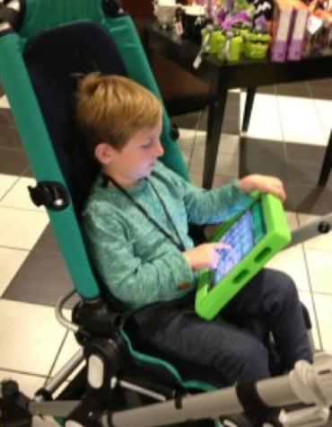 boy in chair using communication device