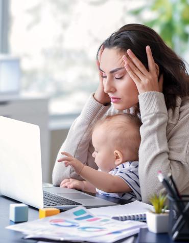 mother on laptop with baby balancing life