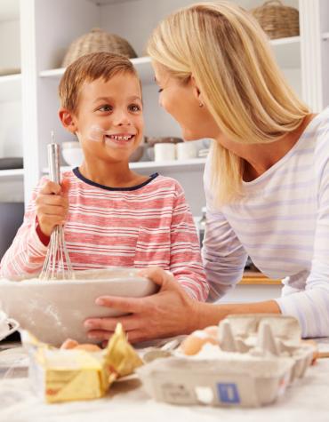mom and son cooking something together