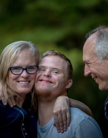 Smiling youth with two adults