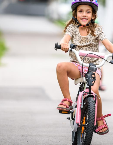 girl riding a 2 wheel bike