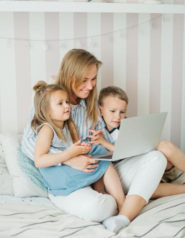 Adult and two children reading together