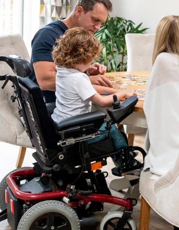 Parents and child in wheelchair
