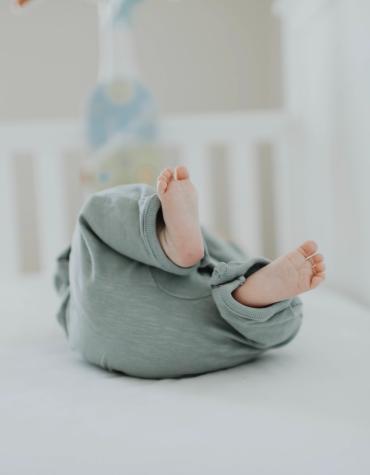 Babys feet laying in crib