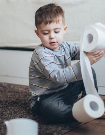 boy playing with toilet paper