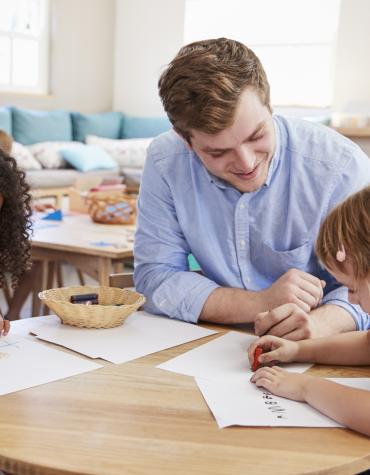 children working at table with adult