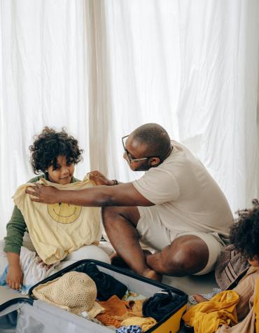 Adult holding up tshirt on child