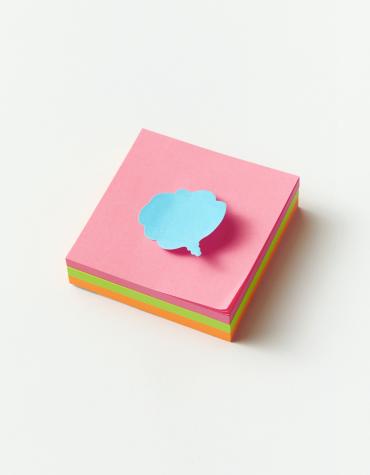 Stack of sticky notes with speech bubble on top