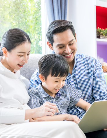 Two adults and child engaging with iPad