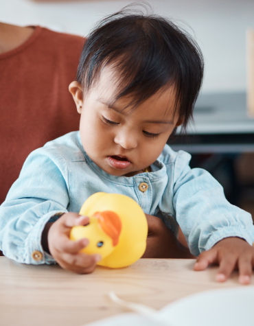 baby playing with rubber duck