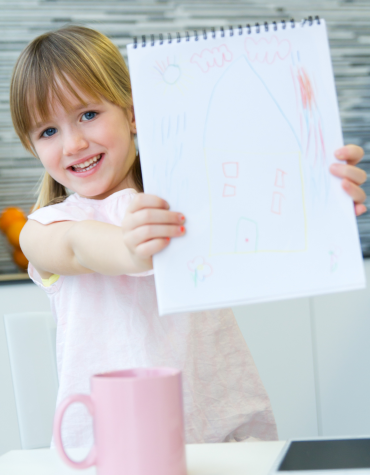 child holding up paper