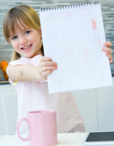child holding up paper
