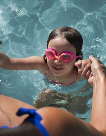 child in pool with parent