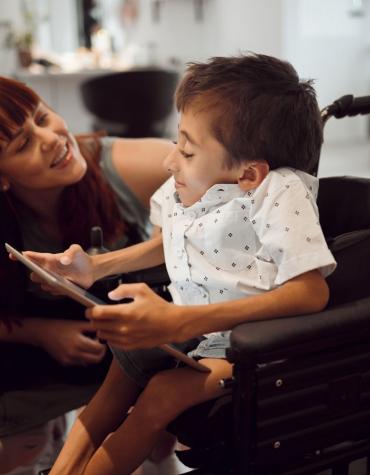 boy in wheelchair with adult