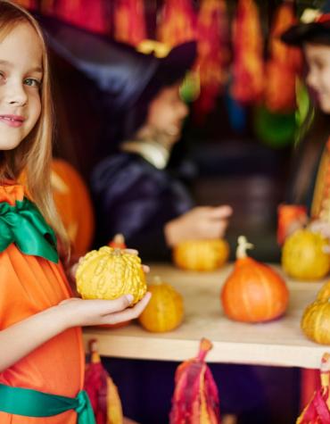 child holding a pumpkin