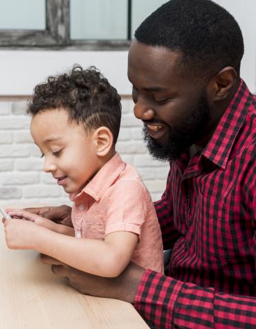 man and boy at table