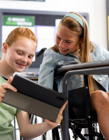 two girls, one in wheelchair