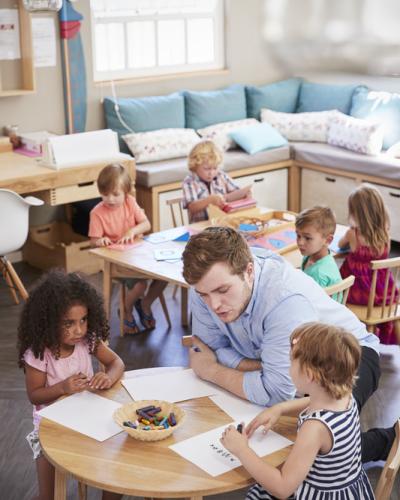 child with instructor working at a table