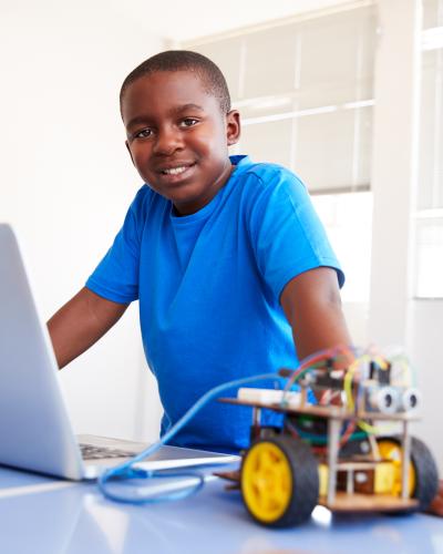 Child standing on a computer